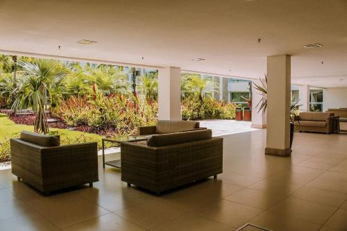 a lobby with two chairs in a building at In Mare Bali Resort Beira Mar by Qavi - 109 in Parnamirim