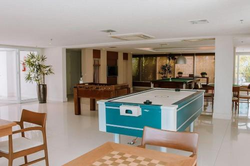 a living room with a pool table and tables and chairs at In Mare Bali Resort Beira Mar by Qavi - 109 in Parnamirim