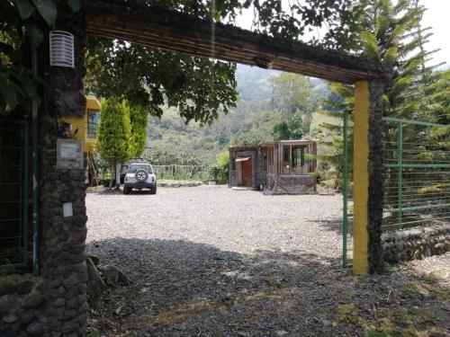 a car parked under an archway in a yard at CASA JUANA DE ORO in Baños
