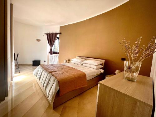 a bedroom with a bed and a vase of flowers on a table at Villa Pignatelli in Bari