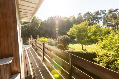 a wooden porch with a view of a park at Ferienhaus Annerose in Wendisch Rietz
