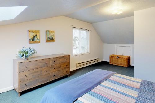 - une chambre avec un lit, une commode et une fenêtre dans l'établissement Newport's Cypress Oceanview Home, à Newport