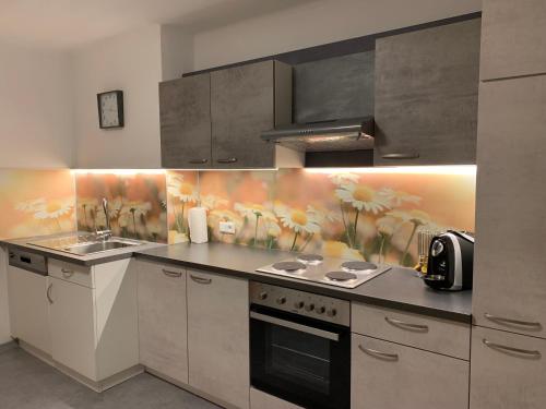 a kitchen with a sink and a stove at Ferienhaus Mörtl in Tröpolach