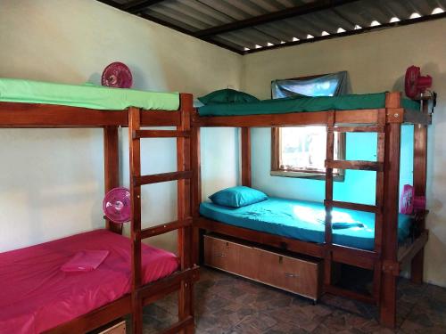 a bedroom with three bunk beds in a room at Cabanas Rusticas in Las Peñitas