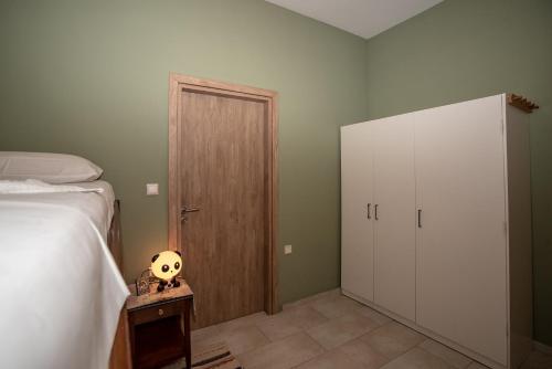 a bedroom with a bed and a wooden door at Michaela's House in Tsikalariá