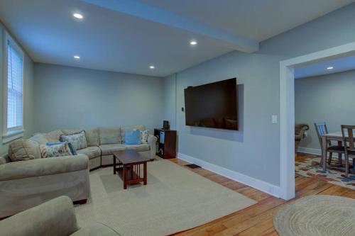 a living room with a couch and a flat screen tv at Calla Lily Farmhouse in Manheim