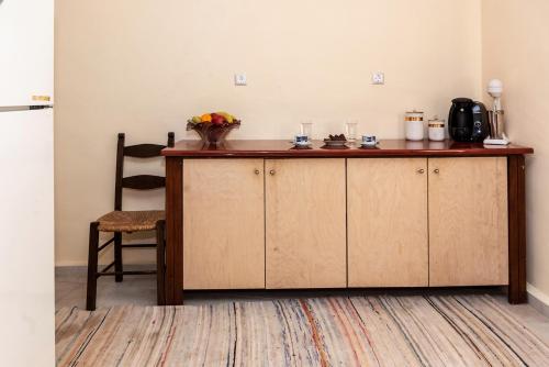 a counter in a room with a table and a chair at Michaela's House in Tsikalariá