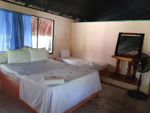Un ou plusieurs lits dans un hébergement de l'établissement ECOHOTEL LAS FLORES Econativo