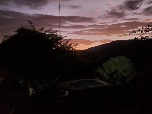 a sunset with a group of birds flying in the sky at Hotel Campestre Villa Nico in Bochalema