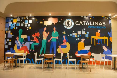 a mural in the lobby of a cafeteria at Hotel Catalinas Tucuman in San Miguel de Tucumán