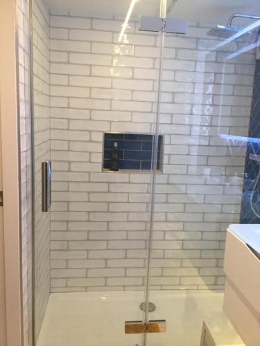 a shower with a glass door in a bathroom at River View in Buxton