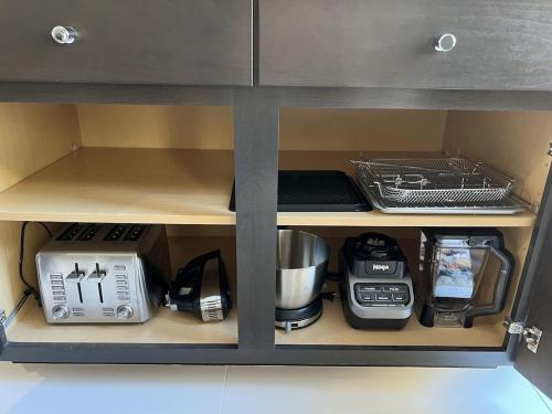a kitchen cabinet with appliances on a shelf at Palm Paradise in Palm Desert