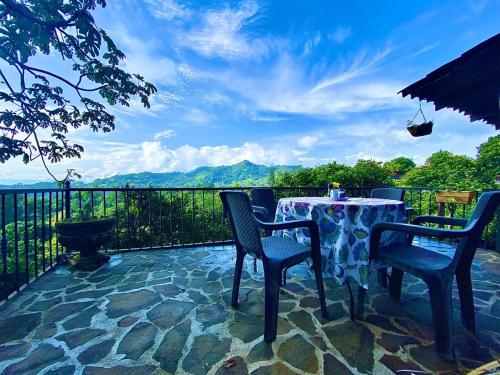 a table and chairs on a patio with a view at Hotel Villas de la Colina in Atenas