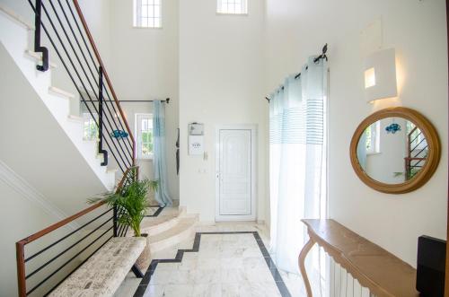 a hallway with a staircase with a mirror and a mirror at Trueby's Tapada - Amazing Villa with Pool & Ocean View By Silver Prop in Nazaré