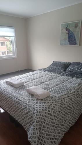 a bedroom with a bed with two pillows on it at Casa Don Alonso Temuco in Temuco