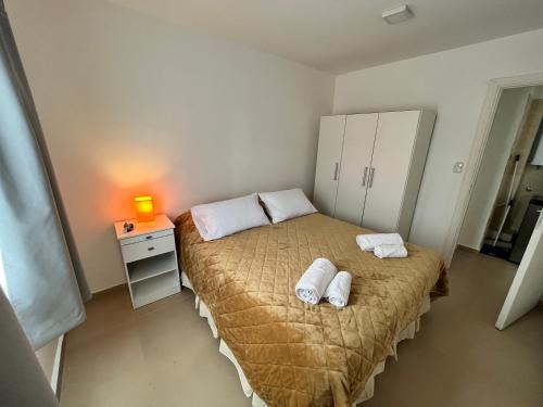 a bedroom with a bed with two towels on it at Bahía Golondrina in Ushuaia