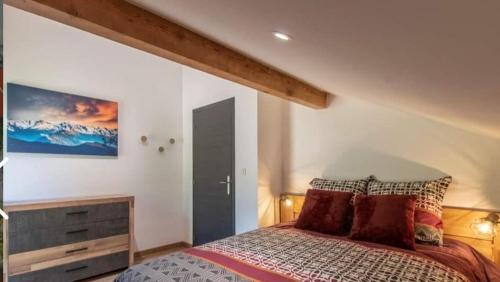 um quarto com uma cama e um quadro na parede em Gite LE SEMNOZ em Montmin