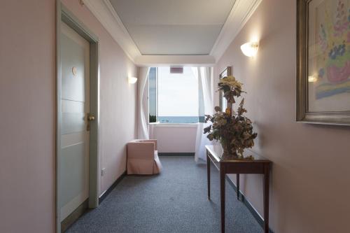 a hallway with a room with a door and a window at Hotel Esplanade in Pescara
