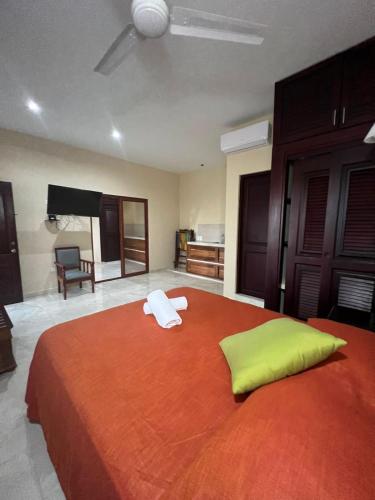 a bedroom with a large bed with two towels on it at Hotel Nojoch che in Cobá