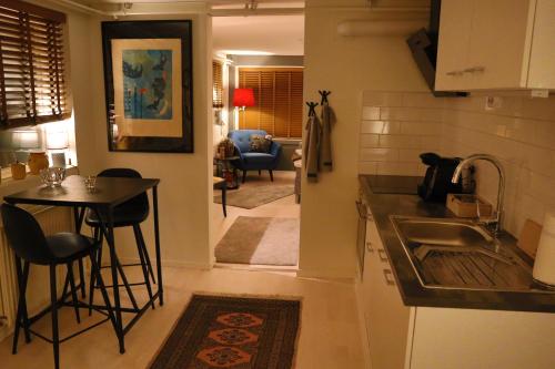 a kitchen with a sink and a table in a room at Göte`s B&B in Tumba