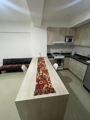 una cocina con una mesa con una alfombra. en Departamento Pueyrredón en Salta