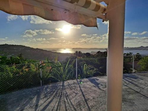 a view of the ocean from the porch of a house at Zowanj 1 - Logement avec vue panoramique in Le Robert