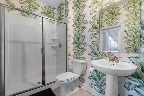 a bathroom with a toilet and a sink and a shower at Disney Dream Vacation Home by Disney in Kissimmee