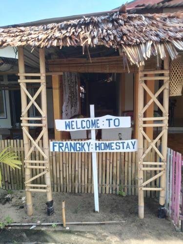 a street sign in front of a house at FRANGKY HOMESTAY in Manado