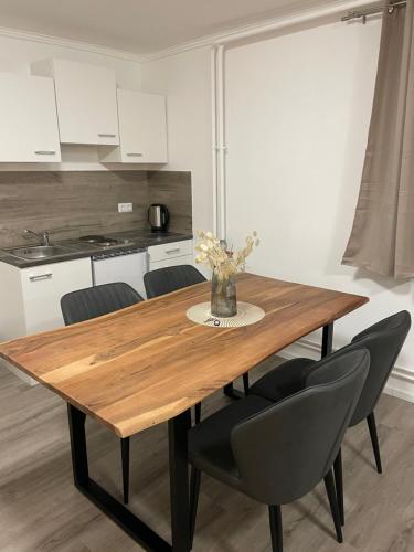 a kitchen with a wooden table and chairs at Giulias Budget Haus in Reutte