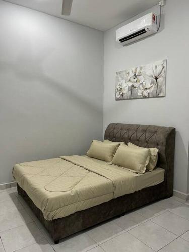 a bed in a white room with avertisement at D'Sara Homestay Fully Furnished 3 bedrooms All Aircond 2 miles centre in Kemaman