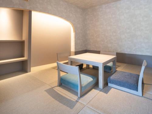 a room with a table and a table and chairs at HAKONE NICA in Hakone