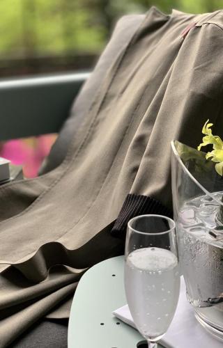a person sitting at a table with two wine glasses at HAKONE NICA in Hakone