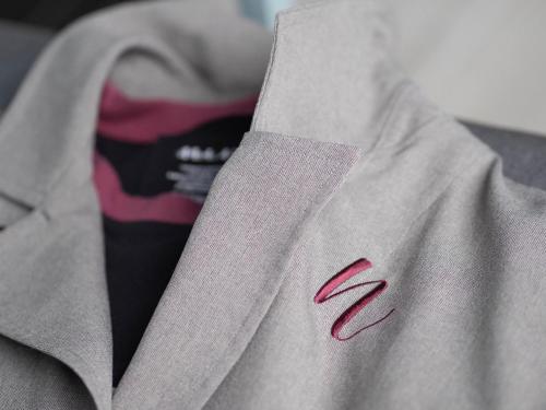 a close up of a gray sweatshirt with a red logo at HAKONE NICA in Hakone