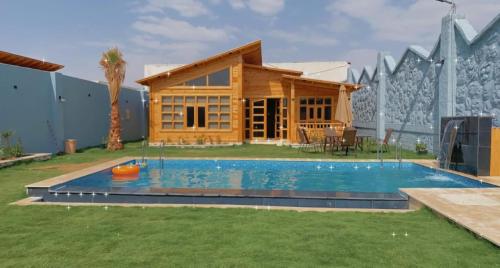 a house with a swimming pool in the yard at شاليهات ريموندا الريفيه الطائف in Taif