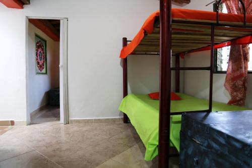 a bedroom with a bunk bed with a green mattress at EL RETORNO in Marinilla