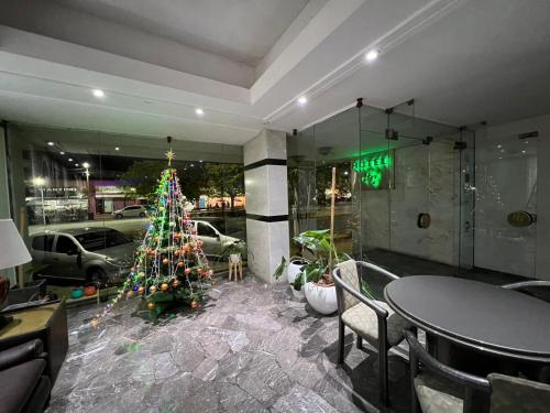 a christmas tree in the lobby of a restaurant at Hotel GHC in San Clemente del Tuyú