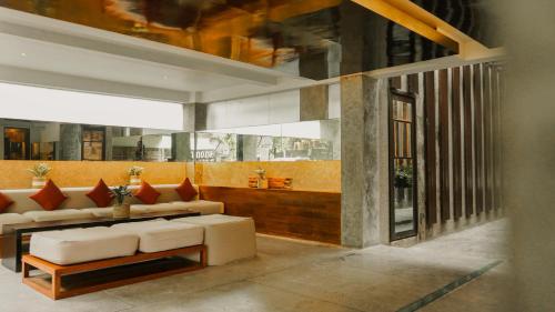 a living room with a white couch and red pillows at Annora Villas Seminyak in Seminyak