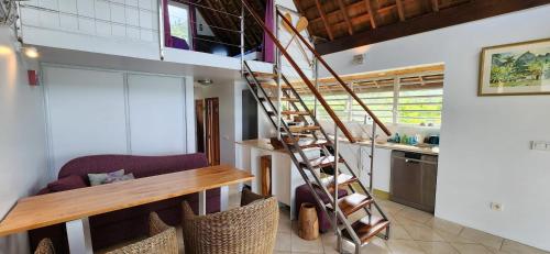 a spiral staircase in a room with a kitchen at Villa Vaihau in Papetoai