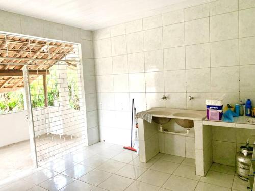 a kitchen with a counter and a sink in a room at Casa do Pôr do Sol in Triunfo