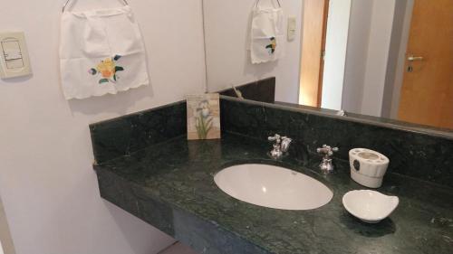 La salle de bains est pourvue d'un lavabo et d'un miroir. dans l'établissement ROCAYAS HOME, à Esquel