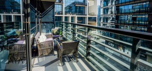 a balcony with chairs and tables on a building at AYA Boutique - City Walk in Dubai