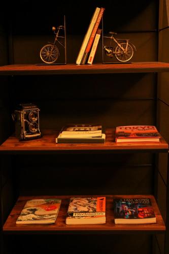 a wooden shelf with books and a bike on it at N Plus Hotel Akihabara in Tokyo
