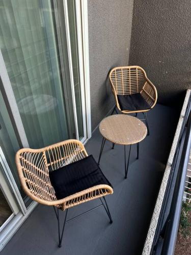 two wicker chairs and a table on a balcony at Tulum Vibes 1 Bedroom Apartment near Boats in Marina Del Rey in Los Angeles