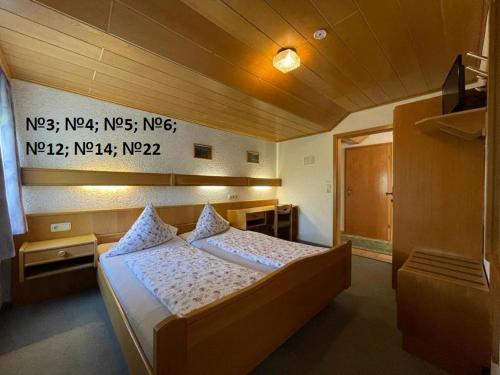 ein Schlafzimmer mit einem Bett in einem Zimmer in der Unterkunft Pension Memminger in Windorf