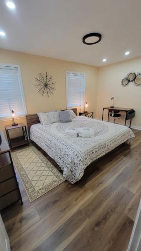 a bedroom with a large bed and wooden floors at HHI Homes LLC in Hilton Head Island