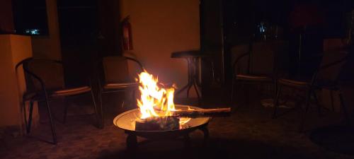 a table with a fire in the middle of a room at Ayllu B&B Ollantaytambo in Ollantaytambo