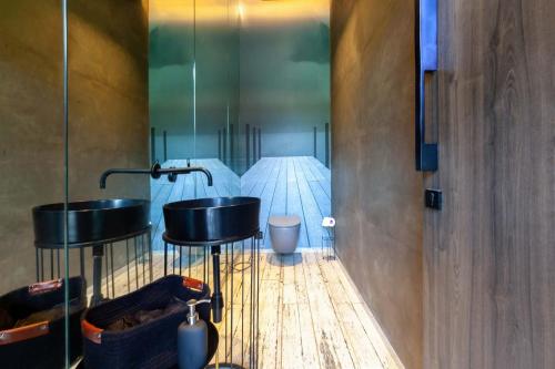a bathroom with two sinks and a toilet at StayVista at The Charcoal Villa Luxury Collection in Alibaug
