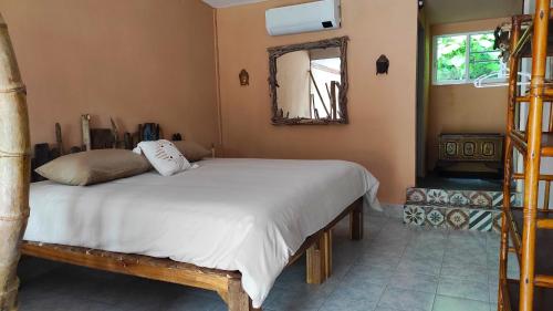 a bedroom with a bed in a room with a mirror at Baan sikhao Yanui in Rawai Beach