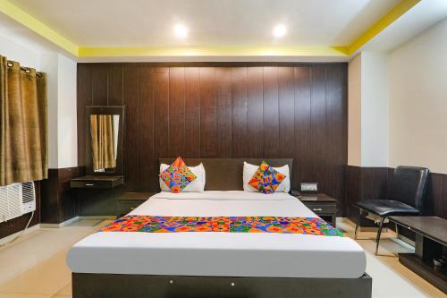 a bedroom with a large bed in a room at FabHotel PS International in Lucknow