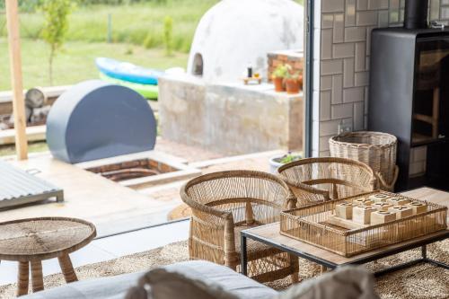 a patio with chairs and a table and a fireplace at Belvidere Country Estate in Karkloof Nature Reserve